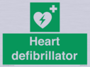 green-background-with-white-text-and-heart-defibrillator-symbol--white-cross-and~